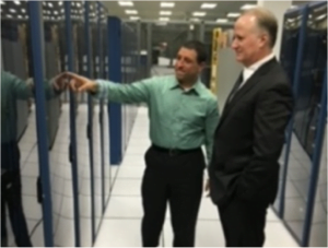 Laurence Allen inspecting backup computer systems designed to operate under prolonged adverse market conditions